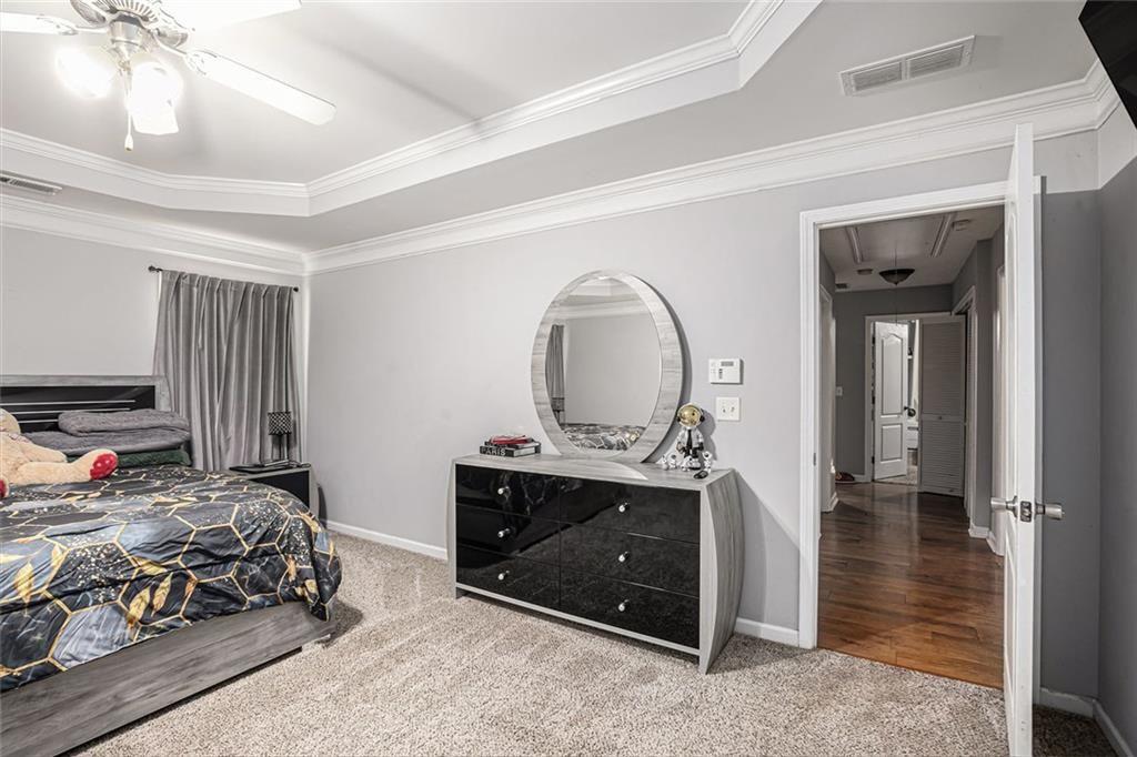 615 Hemlock Court Villa Rica, GA 30180 - Photo 19 of 31 a bedroom with a bed and a chandelier