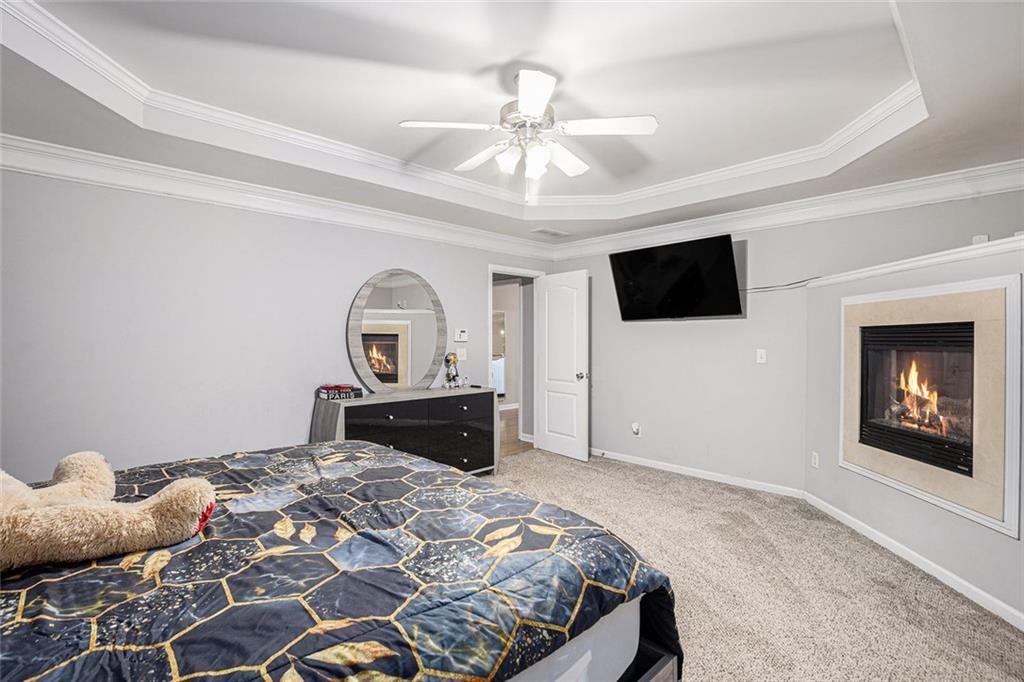 615 Hemlock Court Villa Rica, GA 30180 - Photo 20 of 31 a bedroom with a bed and a flat screen tv