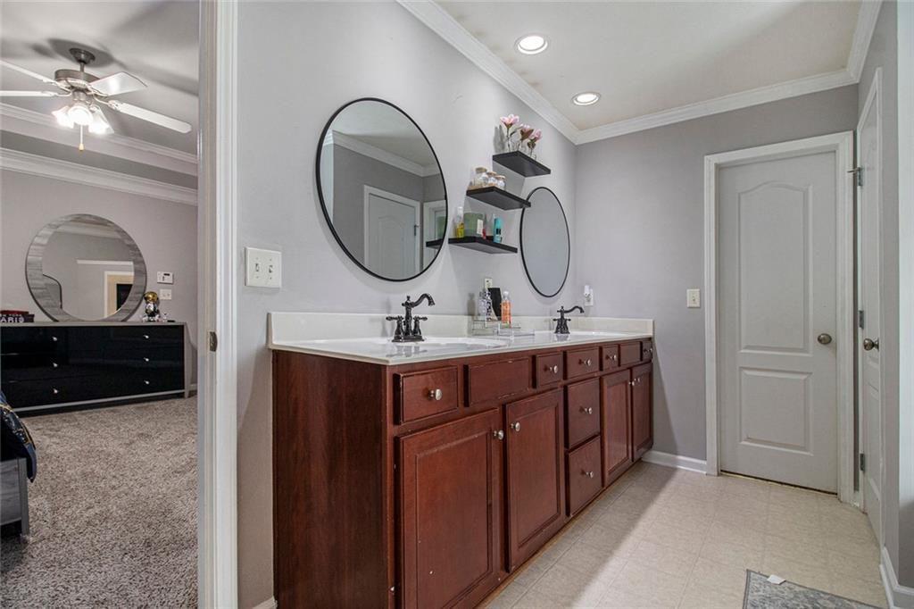 615 Hemlock Court Villa Rica, GA 30180 - Photo 21 of 31 a bathroom with a double vanity sink and a mirror