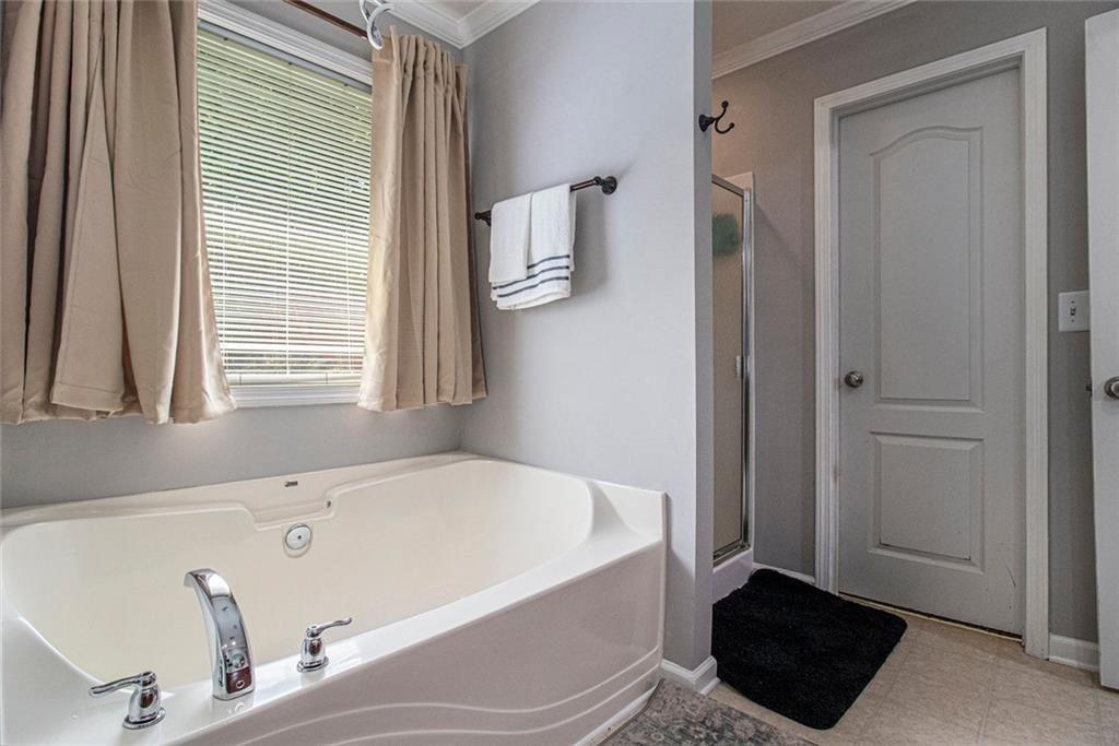 615 Hemlock Court Villa Rica, GA 30180 - Photo 22 of 31 a bathroom with a bathtub and a window