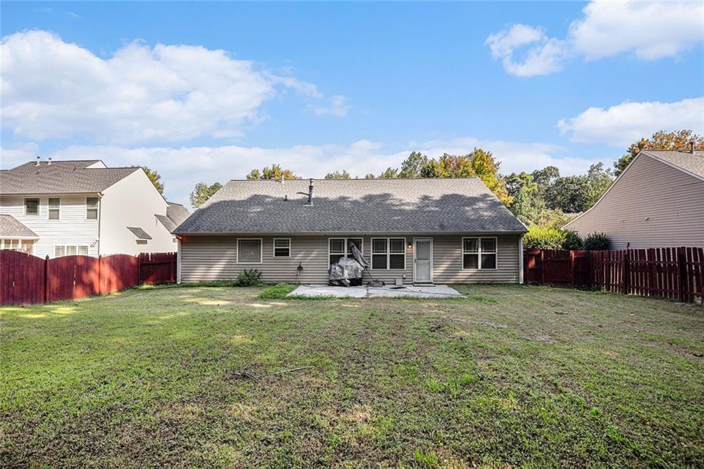 615 Hemlock Court Villa Rica, GA 30180 - Photo 28 of 31 a view of a big house with a big yard and large trees