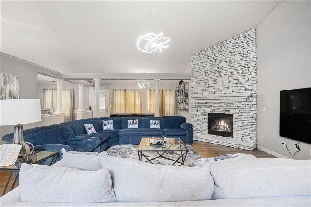615 Hemlock Court Villa Rica, GA 30180 - Photo 4 of 31 a living room with furniture a fireplace and a flat screen tv