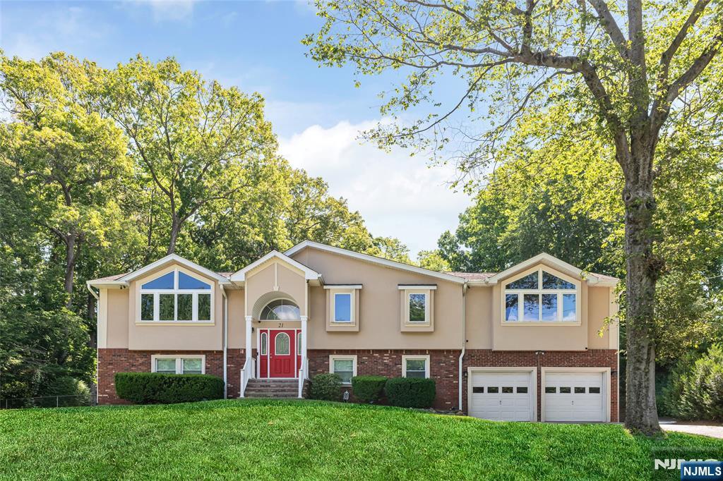 21 Marcia Road Ringwood, NJ 07456 - Photo 2 of 42 a front view of a house with a garden and trees