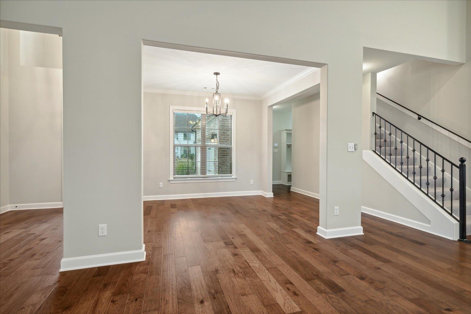 6437 Rutherford Circle Arlington, TN 38002 - Photo 14 of 40 Interior space with ornamental molding, dark wood-type flooring, and a chandelier