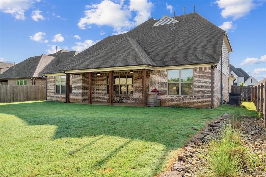 6437 Rutherford Circle Arlington, TN 38002 - Photo 35 of 40 Rear view of property featuring a yard, cooling unit, and a patio