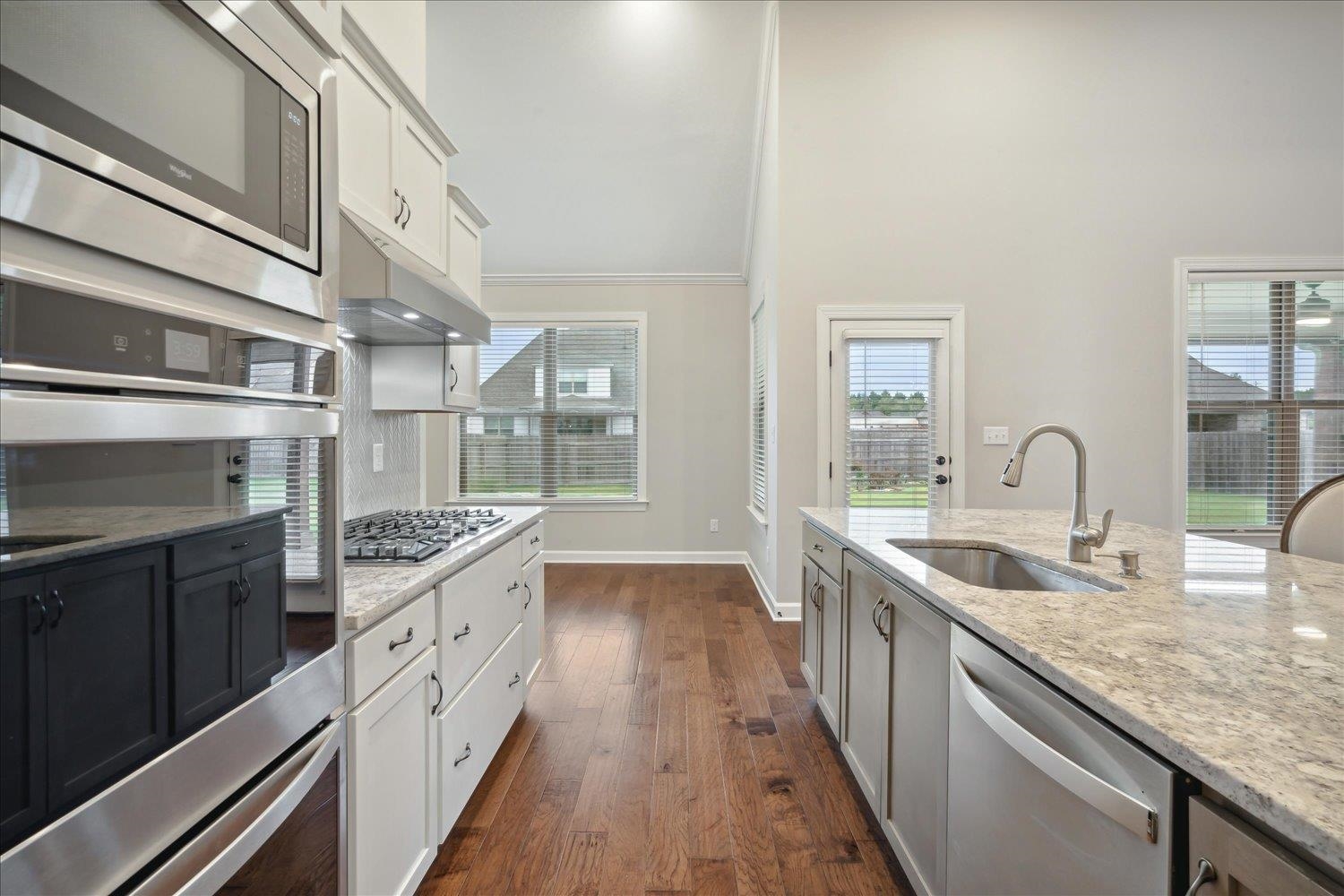 6437 Rutherford Circle Arlington, TN 38002 - Photo 7 of 40 Kitchen featuring dark wood-type flooring, light stone counters, sink, and appliances with stainless steel finishes