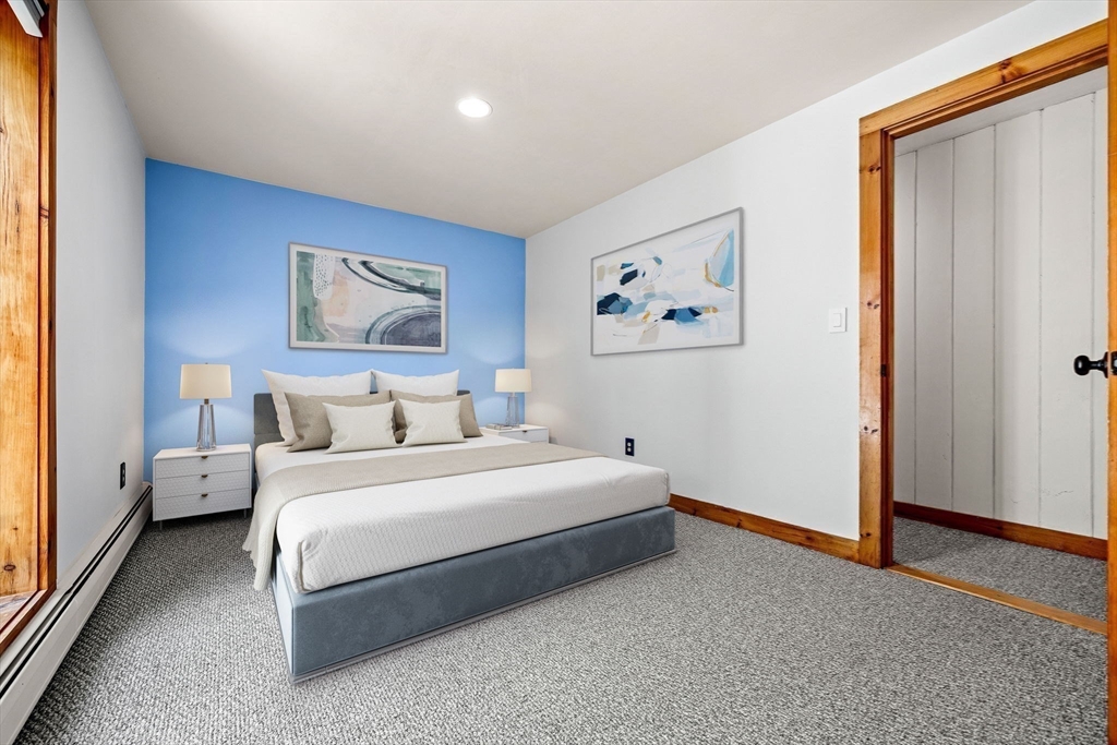 3 Whitman Place Beverly, MA 01915 - Photo 20 of 34 a spacious bedroom with a bed and a painting on the wall