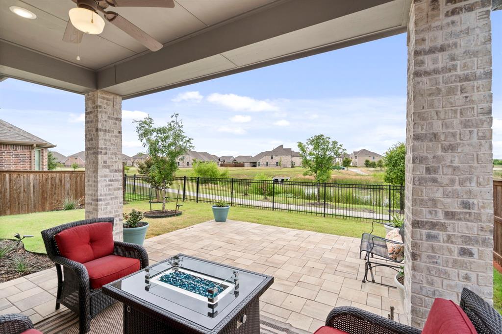 762 Corner Post Path Celina, TX 75009 - Photo 29 of 38 The back patio is the perfect place to unwind and enjoy the view. A motorized privacy shade has been recently added.