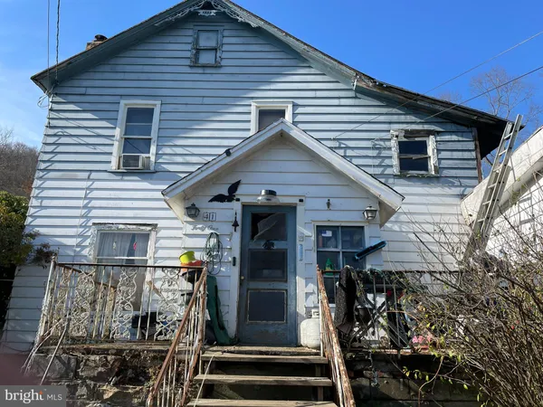a view of a house with wooden walls and stairs
