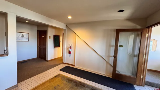 a view of a hallway with bathroom and a closet