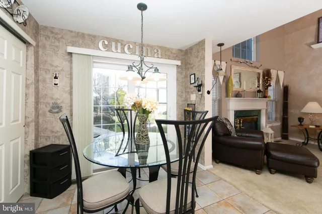 a view of a dining room with furniture a chandelier and wooden floor