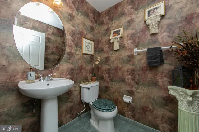 a bathroom with a sink toilet and mirror