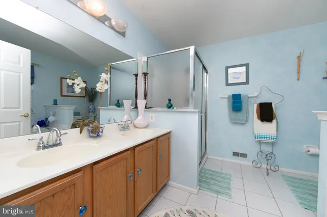 a white bath tub sitting next to a white sink