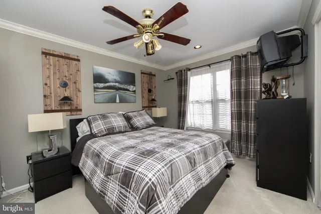 a bedroom with a large bed and a large window