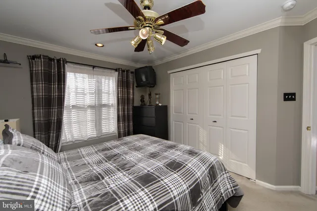 a bedroom with a bed and a television