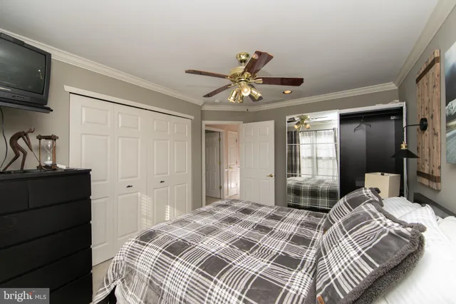 a bedroom with two beds and a chandelier
