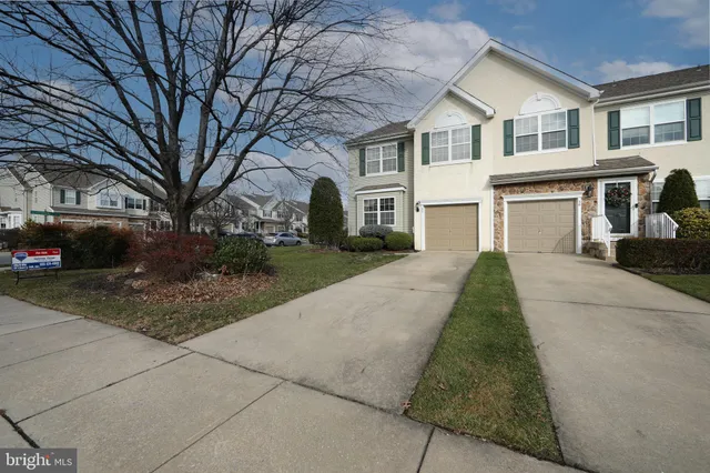a backyard of a house with a garden and barbeque oven