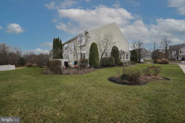 a view of a house with backyard and porch