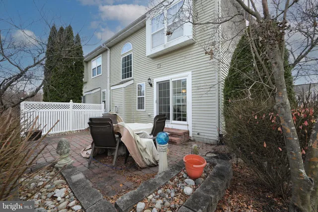 a view of a backyard with table and chairs and a fire pit