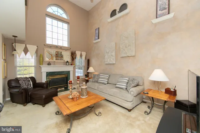 a living room with furniture fireplace and a window