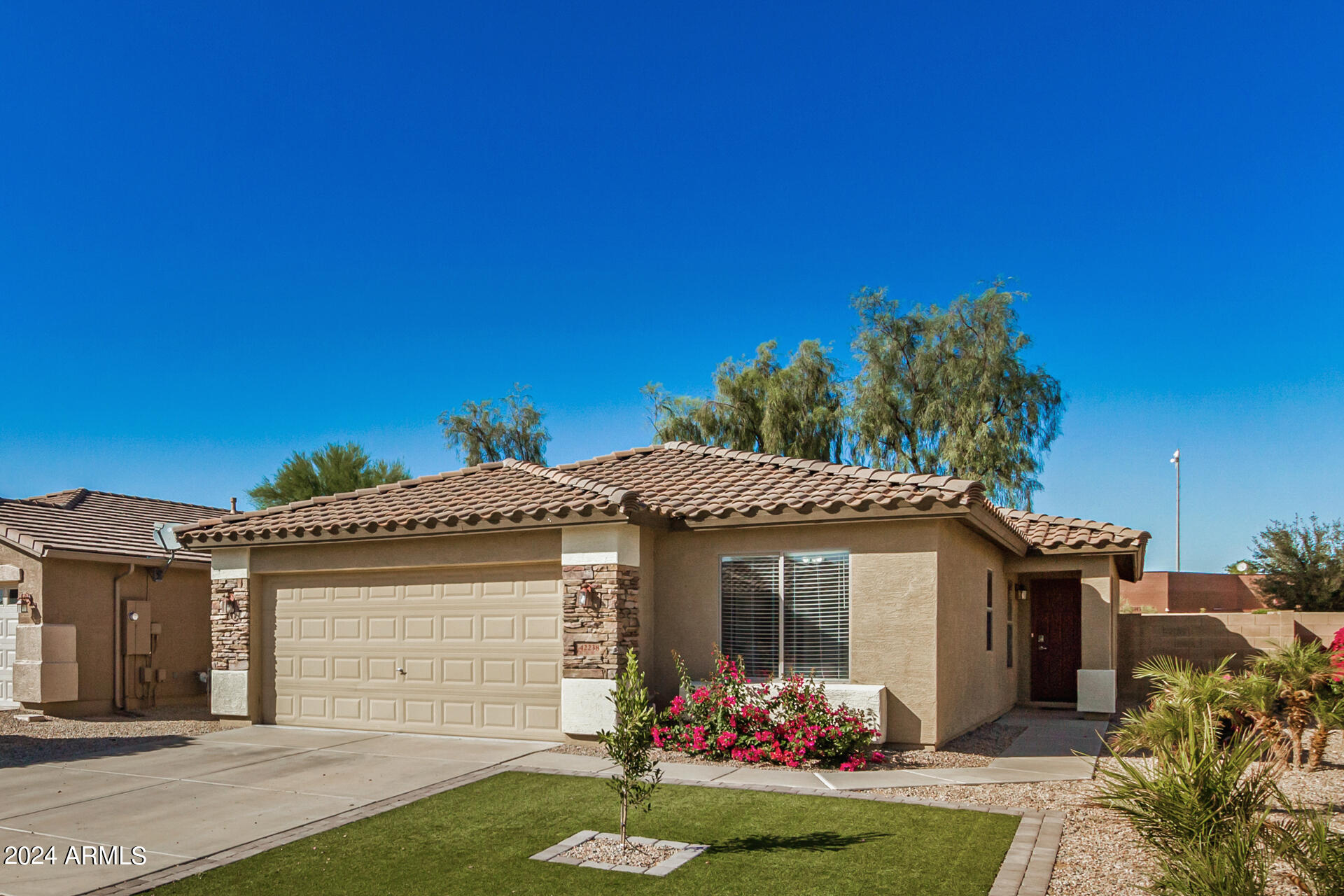 42238 West Venture Road Maricopa, AZ 85138 - Photo 3 of 33 a front view of a house with a yard
