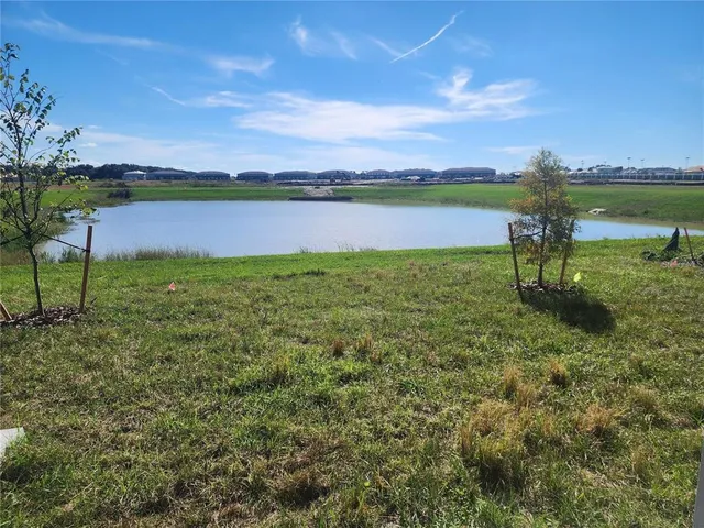 a view of a lake with houses in the back