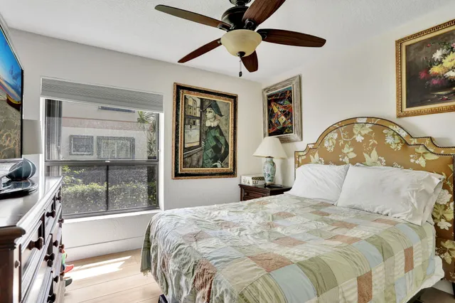 a bedroom with a large bed and a large window