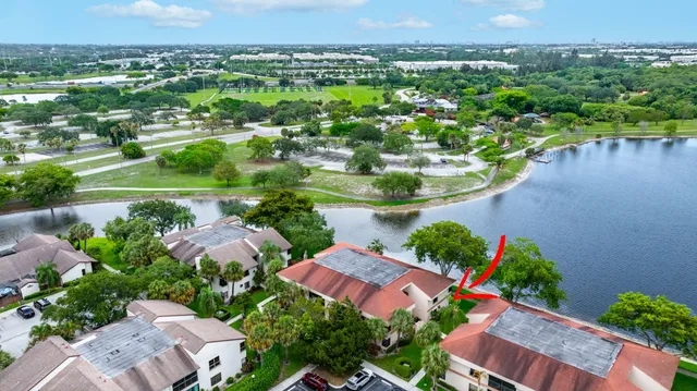 an aerial view of residential houses with outdoor space and lake view