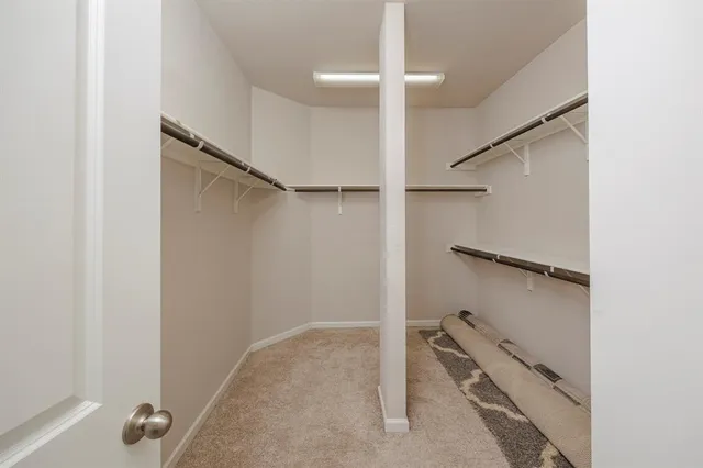 a spacious bathroom with a mirror a double vanity sink and a shower