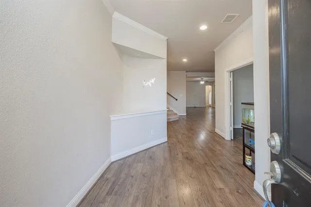 a view of a hallway with wooden floor