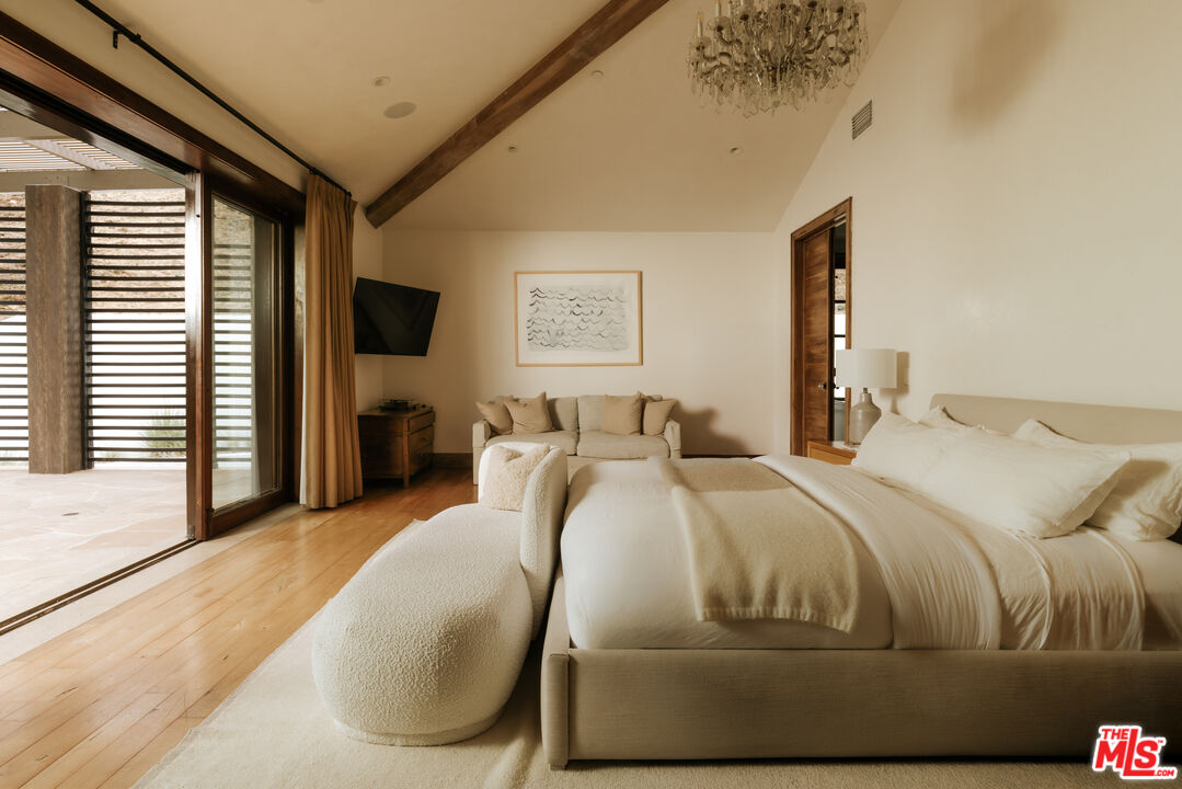 1105 Rivas Canyon Road Pacific Palisades, CA 90272 - Photo 30 of 49 a bedroom with a bed and a flat tv screen