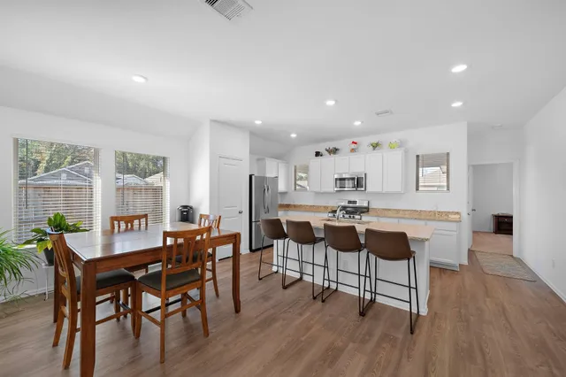 a view of a dining room with furniture and wooden floor