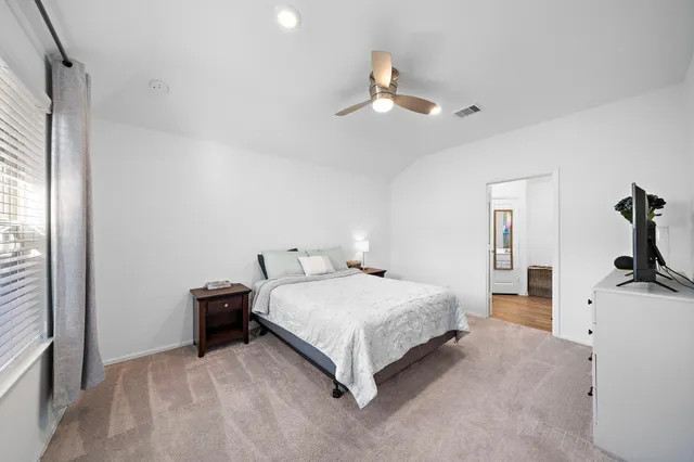 a bedroom with a bed and ceiling fan