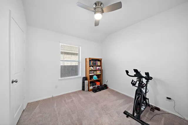 a room with gym equipment and a window