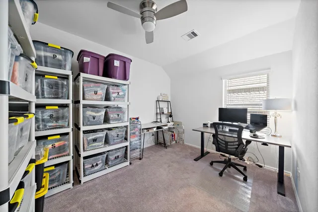 a view of a workspace with bookshelf