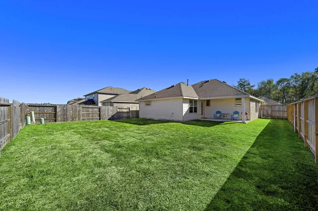 a view of a house with a big yard plants and a big yard