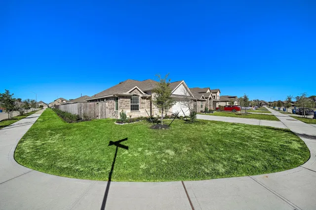 a view of a house with a small yard and a small pool