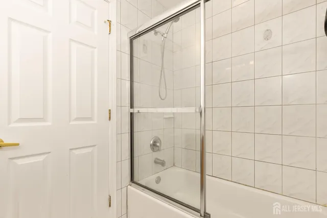 a bathroom with a glass shower door