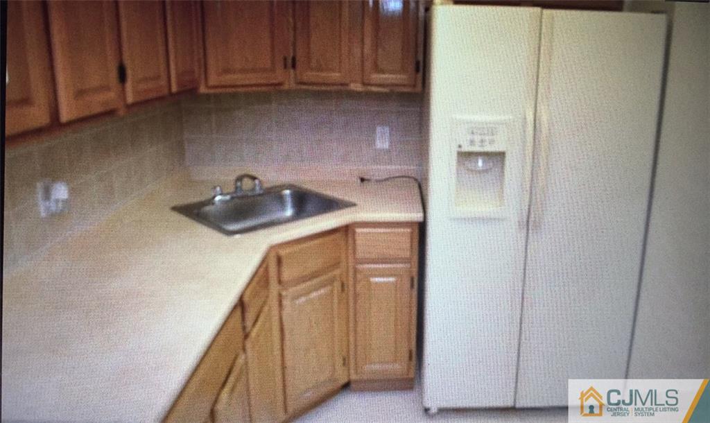 71 College Drive Edison, NJ 08817 - Photo 2 of 12 a utility room with dryer and washer