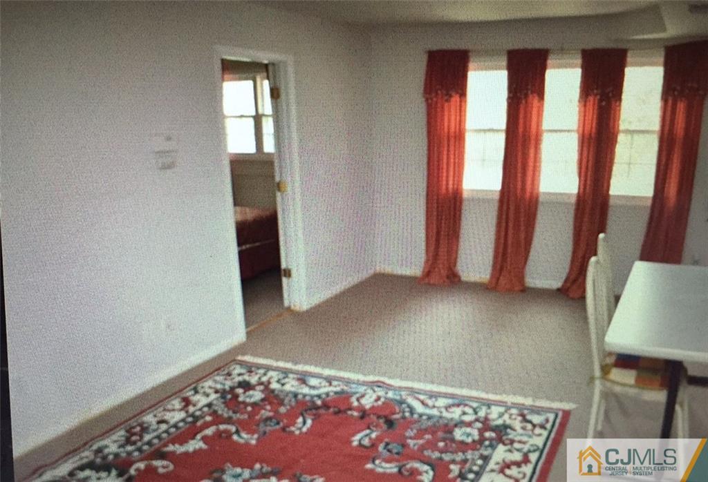71 College Drive Edison, NJ 08817 - Photo 7 of 12 a view of an empty room with a window and a fireplace