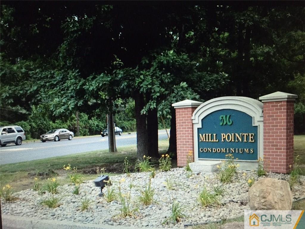 71 College Drive Edison, NJ 08817 - Photo 9 of 12 a sign that is sitting on a brick wall