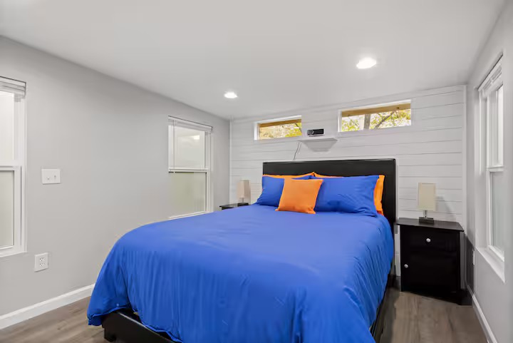 307 East 35th Street, Unit A Austin, TX 78705 - Photo 34 of 40 Natural light floods this inviting bedroom, featuring stylish wood flooring and convenient recessed lighting.