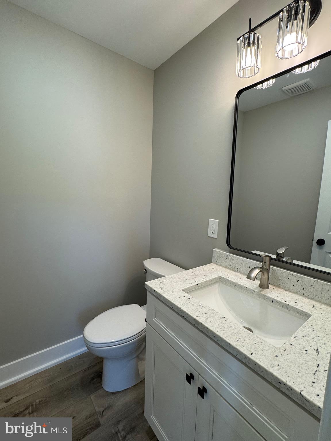 3706 South Mountain Road Knoxville, MD 21758 - Photo 12 of 12 a bathroom with a granite countertop toilet and sink