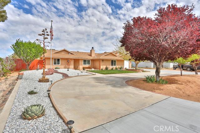22298 Broken Lance Road Apple Valley, CA 92307 - Photo 1 of 1 a front view of a house with a yard
