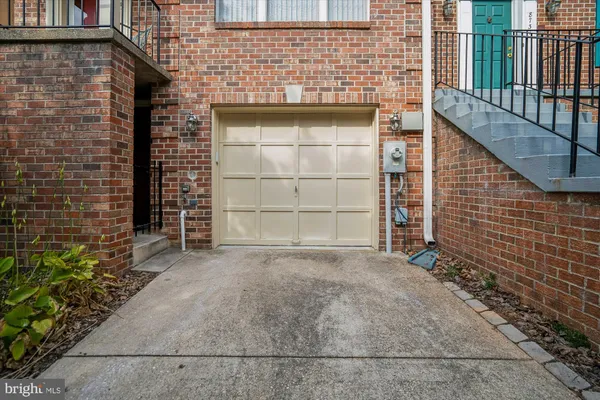 a view of a patio with couches chairs potted plants and floor to ceiling window