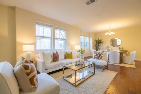 a living room with furniture and a wooden floor