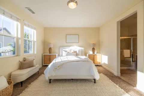a living room with furniture a window and a potted plant
