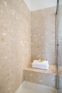 a bedroom with bed and a potted plant