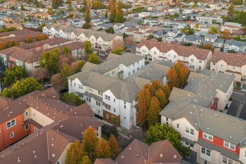 an aerial view of residential houses with outdoor space