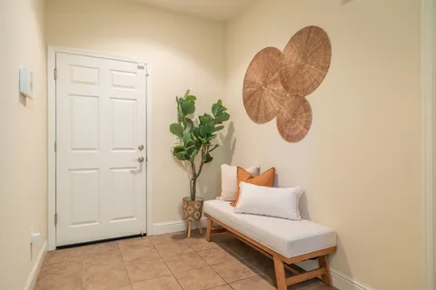a living room with furniture and a potted plant